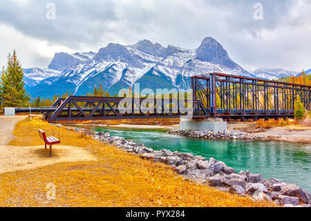 Historic Canmore Engine Bridge is a truss bridge over the Bow River in the Canadian Rockies of Alberta. The bridge was built by the Canadian Pacific R Stock Photo