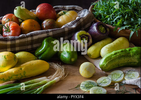 Fresh cucumbers, tomatoes, squash, onions, peppers and arugula. Stock Photo