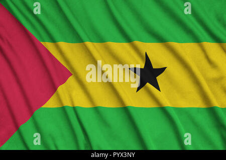 Sao Tome and Principe flag  is depicted on a sports cloth fabric with many folds. Sport team waving banner Stock Photo