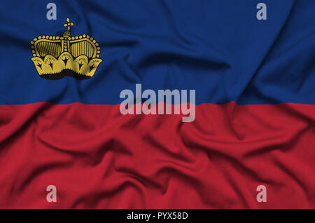 Liechtenstein flag  is depicted on a sports cloth fabric with many folds. Sport team waving banner Stock Photo