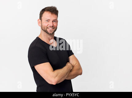 Happy, handsome young man in black smiling portrait against white background Stock Photo