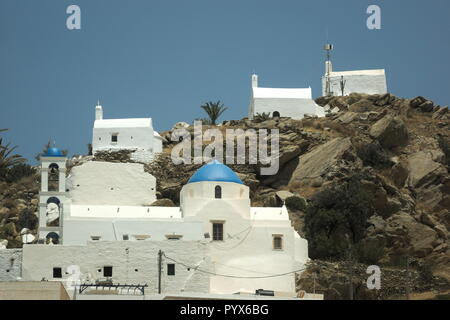 Greece the island of Ios. A view to the old town with three white ancient chapels perched high on a hill, on a perfect summers day. Copy space. Stock Photo