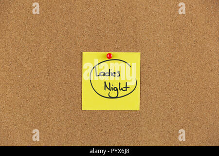 Note on a cork board with writing ladies night out. Stock Photo