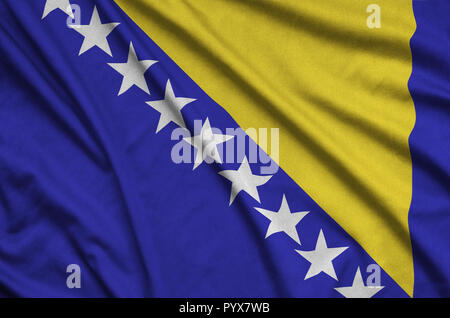 Bosnia and Herzegovina flag  is depicted on a sports cloth fabric with many folds. Sport team waving banner Stock Photo