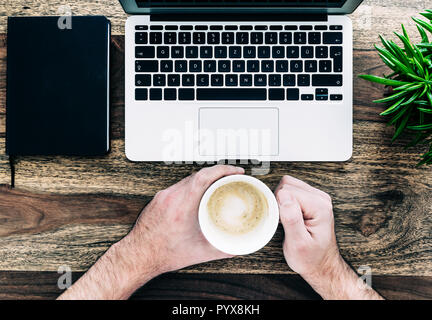 man drinking coffee in front of laptop computer Stock Photo