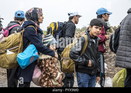 BERKASOVO, SERBIA - OCTOBER 17, 2015: Group of refugees, mainly children, waiting to cross the Croatia Serbia border, between the cities of Bapska and Stock Photo
