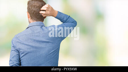 Handsome middle age elegant senior man over isolated background Backwards thinking about doubt with hand on head Stock Photo