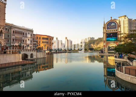 Macau, China - December 9, 2016: The Venetian luxury shopping centre, mirrored on lake at twilight, the largest casino in the world and the largest single structure hotel building in Asia. Stock Photo