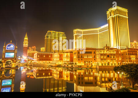 Macau, China - December 9, 2016: Venetian Macao by night, golden colors of this resort and Casino at night seen from Galaxy Cotai Strip. Gambling tourism is Macau's biggest source of revenue. Stock Photo