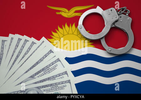 Kiribati flag  with handcuffs and a bundle of dollars. The concept of illegal banking operations in US currency. Stock Photo