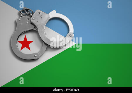 Djibouti flag  and police handcuffs. The concept of crime and offenses in the country. Stock Photo