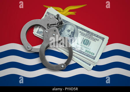 Kiribati flag  with handcuffs and a bundle of dollars. Currency corruption in the country. Financial crimes. Stock Photo