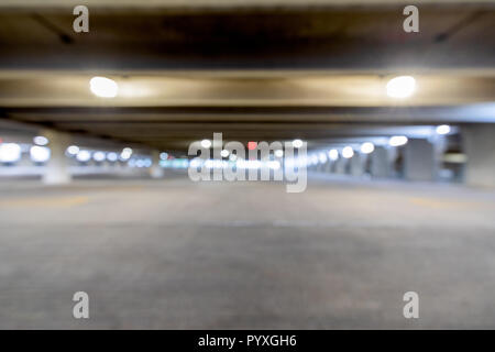 Out of focus parking garage with lights on the ceiling. Stock Photo