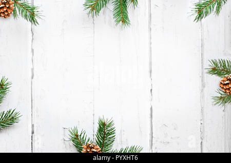 Christmas background with fir branches, pinecones on the old wooden board in vintage style. Stock Photo
