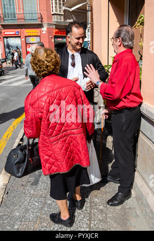 Elderly Spain couple both wearing matching red clothing Stock Photo