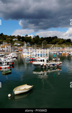 Boats in the harbour at Lyme Regis in Dorset under a stormy sky Stock Photo