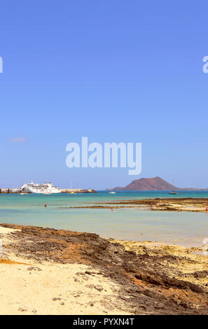 ARMAS ferry in Corralejo harbour with the Isla de Lobos in the backgrou Stock Photo