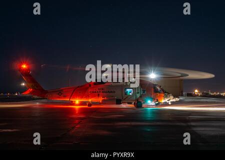 A Coast Guard Air Station Kodiak aircrew prepares to take off to conduct a night flight from the forward operating location in Kotzebue, Alaska, Oct. 28, 2018. Aircrews are forward deployed to Kotzebue in in support of Arctic Shield to be more geographically available to respond to search and rescue cases. U. S. Coast Guard photo by Petty Officer 1st Class Bradley Pigage. Stock Photo