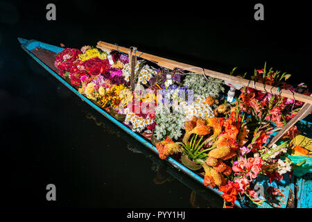 Shikaras are the common transport for people and goods like flowers on Dal Lake Stock Photo