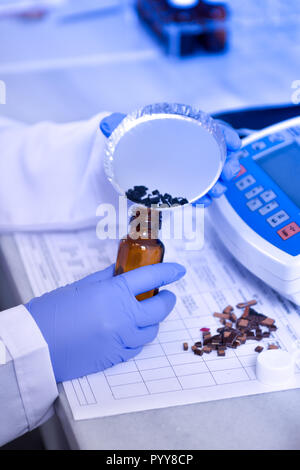 Liquid bottles in laboratory and particle analysis Stock Photo