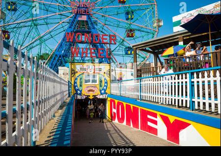 NEW YORK CITY - CIRCA JUNE 2017: Visitors pass through a tunnel connecting the Coney Island boardwalk to the amusement park filled with rides Stock Photo