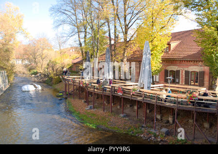 Cafeteria restaurant on the river in Užupis, a neighborhood in Vilnius, the capital of Lithuania, largely located in Vilnius' old town, UNESCO Stock Photo