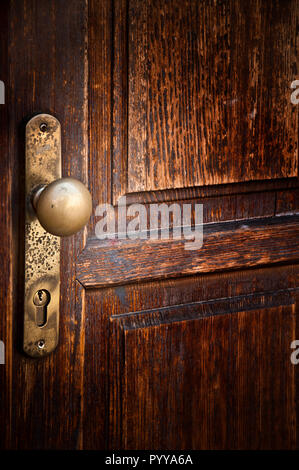 door knob and lock of an old wooden door Stock Photo