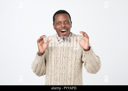Shocked black male says wow, looks with wide opened eyes and rounded mouth Stock Photo