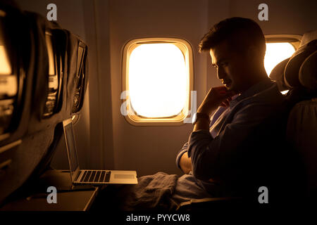 Young men by plane Stock Photo