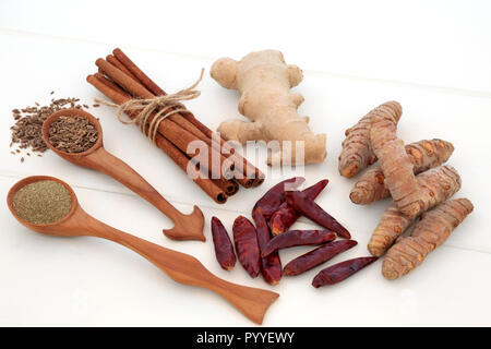 Spice selection used for helping with weight loss and fat busting with fresh and dried turmeric, cumin, ginger, chilli, cinnamon and gymnema sylvestre Stock Photo