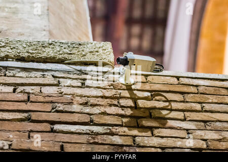 Modern surveillance camera on old brick wall Stock Photo