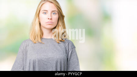 Beautiful young woman wearing oversize casual t-shirt over isolated background depressed and worry for distress, crying angry and afraid. Sad expressi Stock Photo