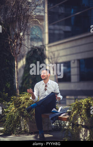 Handsome businessman uses pc tablet at urban place Stock Photo