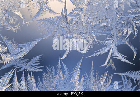 Frost forms in patterns on window glass on a cold winter morning Stock Photo