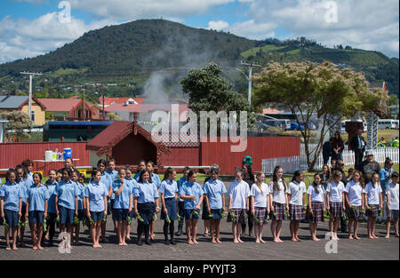 Schoolchildren line up to see the arrival of the Duke and Duchess of Sussex during a visit to Te Papaiouru, Ohinemutu, in Rotorua, before a lunch in honour of Harry and Meghan, on day four of the royal couple's tour of New Zealand. Stock Photo