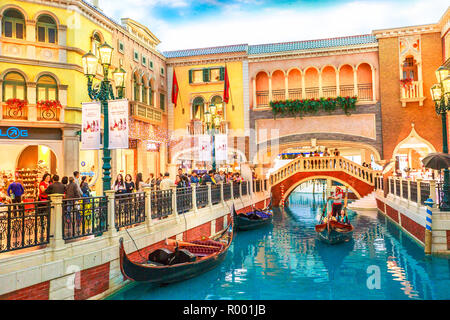 Macau, China - December 9, 2016: Canals with Venetian bridge of the Venetian style Casino. Inside luxury shopping mall in the Venetian Hotel in Cotai Strip. Stock Photo