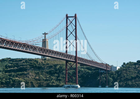 Tagus River (Rio Tejo) with Ponte 25 de Abril suspension bridge and the statue of Christ, Cristo Rei, Lisbon, Portugal. Stock Photo