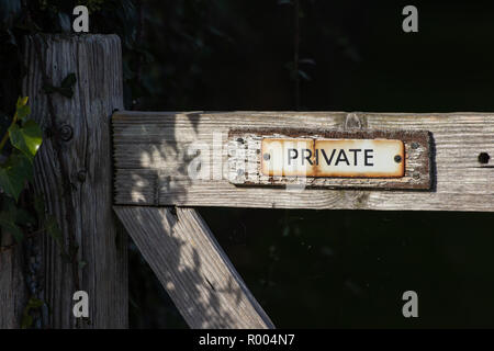 A rusty Private sign on an old wooden gate Stock Photo