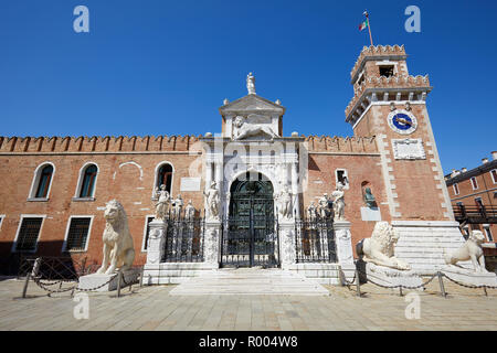 Venetian Arsenal entrance with white statues in a sunny summer day in Venice, Italy Stock Photo