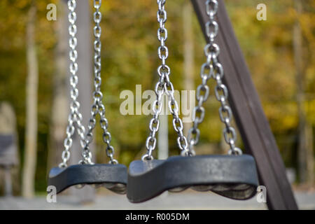 Playground swing seat in chains Stock Photo