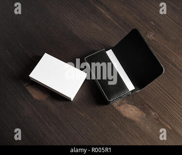 Blank business cards and leather business card holder on wooden background. Stock Photo