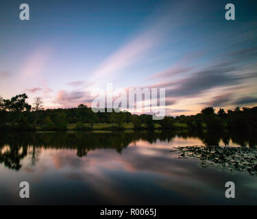 sunset reflections on a calm lake Stock Photo