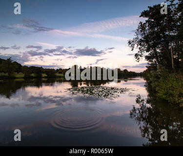 sunset reflections on a calm lake Stock Photo