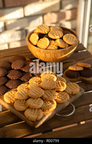 Peanut and chocolate cookies on wooden background in sun rays Stock Photo