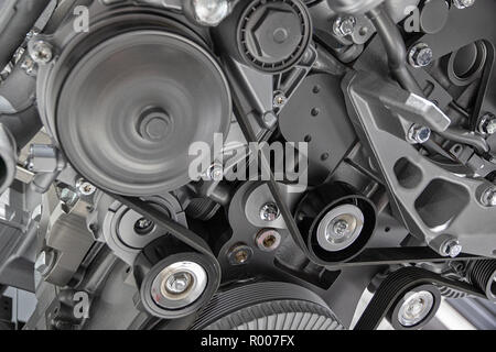 Close up shot of the pulley system and drive belt on a powerful diesel engine. Stock Photo