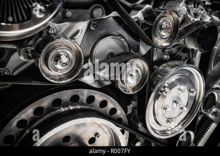 Close up shot of the pulley system and drive belt on a powerful diesel engine. Stock Photo
