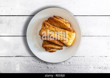 top view of Franzbrötchen pastry on plate on rustic white wooden table Stock Photo