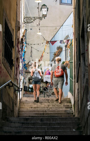Tourists in the narrow streets of the Alfama district, Lisbon, Portugal. Stock Photo