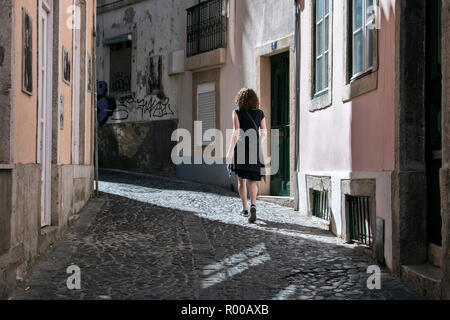 Tourist in the narrow streets of the Alfama district, Lisbon, Portugal. Stock Photo