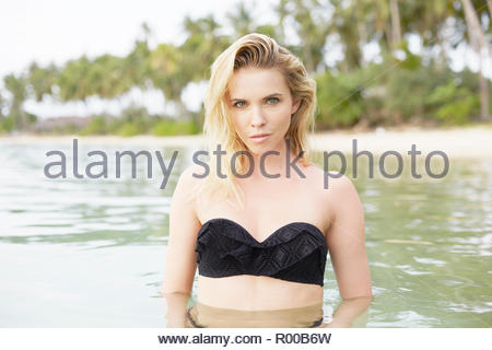 Young woman wearing black bikini in sea